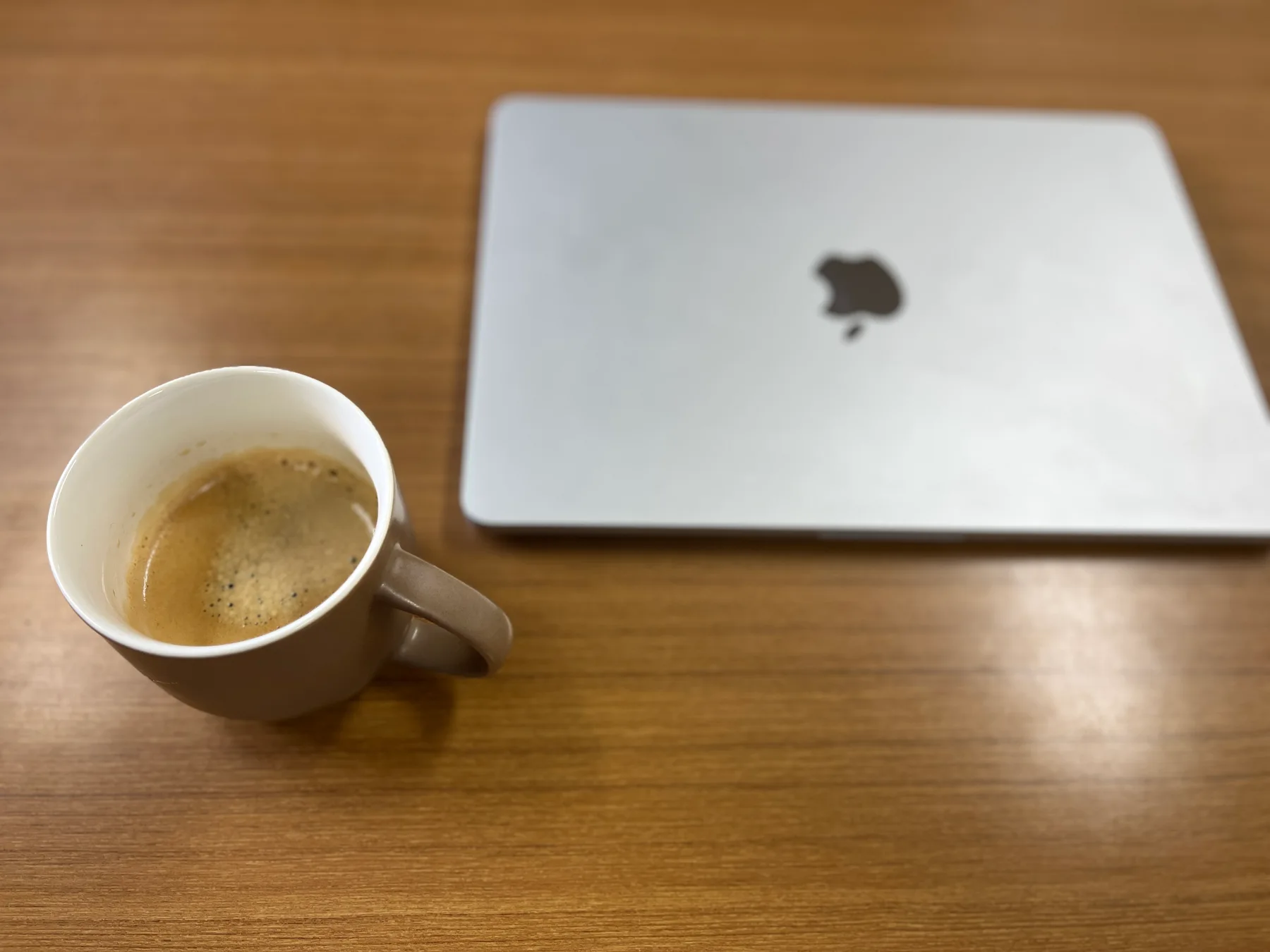 Coffee and a MacBook Air on a table.